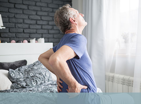 Image of a man in bed with a painful back